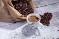 Coffee beans in sack and cup of coffee Royalty Free Stock Photo