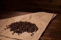 Coffee beans on sacking on the wooden background