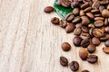 Coffee beans scattered on a light wooden table, top view, closeup grains, place to insert text, copy space