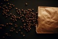 Coffee beans scattered from paper pack on black background Flat lay. Fresh aromatic roasted coffee beans top view. Coffee shop