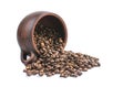 Coffee beans are scattered from an upturned earthenware mug on a white isolated background Royalty Free Stock Photo
