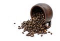 Coffee beans are scattered from an upturned earthenware mug on a white isolated background Royalty Free Stock Photo