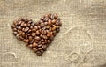 Coffee beans in the shape of a heart on the burlap Royalty Free Stock Photo