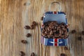 Coffee beans in the small case with britain flag pattern on wooden background