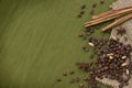Coffee beans and some spices on green background Royalty Free Stock Photo