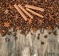 Coffee beans spices cinnamon cloves star anise wooden background Royalty Free Stock Photo