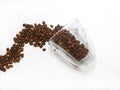 coffee beans spilled from glass cup on white background Royalty Free Stock Photo