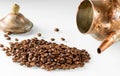 Coffee beans spilled out of an old copper coffee pot lying on its side. Royalty Free Stock Photo