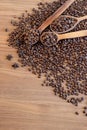 Coffee beans spilled on a wooden table