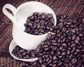 Coffee Beans Spilling from a Cup Royalty Free Stock Photo