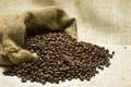 Coffee Beans Spilling Out On Burlap Background Royalty Free Stock Photo