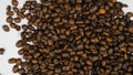 The coffee beans spin rotate quickly fast fly, dispart, splash to the sides with centrifugal coriolis force. Coffee