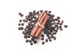 Coffee beans and sticks of cinnamon on the white isolated background.