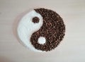 Coffee beans on the table and granulated sugar in yin-yang