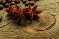 Coffee beans and three star aniseas closeup on a wooden board, with blurred depth of field. The concept of taste of coffee Royalty Free Stock Photo