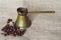 Coffee beans and Turkish coffee in a traditional copper coffee pot Royalty Free Stock Photo