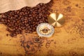 Coffee Beans and Vintage Compass with  magnifying glasson an old world map - trade and explorer concept Royalty Free Stock Photo