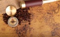 Coffee Beans and Vintage Compass with  magnifying glasson an old world map - trade and explorer concept Royalty Free Stock Photo