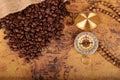 Coffee Beans and Vintage compass on an old world map - trade and explorer concept . Royalty Free Stock Photo