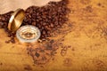 Coffee Beans and Vintage compass on an old world map - trade and explorer concept . Royalty Free Stock Photo