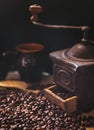 Coffee beans and vintage coffee grinder. Roasted coffee beans in a vintage setting. Dark still life Royalty Free Stock Photo