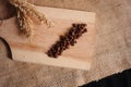 Coffee beans and wheat on wooden background and burlap sack texture Royalty Free Stock Photo