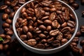 coffee beans in a white bowl on a black surface Royalty Free Stock Photo