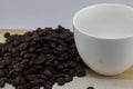 Coffee beans and glass are white on wood. Royalty Free Stock Photo