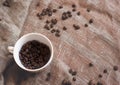 Coffee beans and a white cup on brown rustic raw sackcloth fabric photo. A4 A5 A3 international paper slide poster card with free