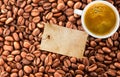 Coffee beans, white cup of coffee and blank tag Royalty Free Stock Photo