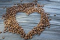 Coffee beans on wooden background. Coffee beans in the form of heart. Valentine`s Day Royalty Free Stock Photo