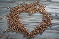 Coffee beans on wooden background. Coffee beans in the form of heart. Valentine`s Day Royalty Free Stock Photo