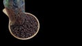 Coffee beans on a wooden plank and put in a glass jar on a black background Royalty Free Stock Photo