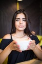 Coffee. Beautiful Girl Drinking Tea or Coffee in Cafe. Beauty Model Woman with the Cup of Hot Beverage. Royalty Free Stock Photo