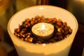 Coffee beens and candles in a glass vase