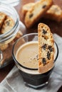 Coffee with biscotti or cantucci on wooden vintage table, traditional Italian biscuit