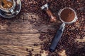 Coffee. Black coffee with coffee beans and portafilter on old oak wooden table