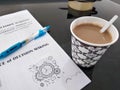 coffee, blue pen, and a book with DECISION MAKING written on it and an explanation in Indonesian. Royalty Free Stock Photo