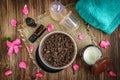 Coffee body scrub, sugar and coconut oil, essential oils, massage vacuum jars on dark wooden rustic table with pink flowers Royalty Free Stock Photo