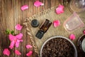 Coffee body scrub, sugar and coconut oil, essential oils, massage vacuum jars on dark wooden rustic table with pink flowers Royalty Free Stock Photo