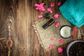 Coffee body scrub, sugar and coconut oil, essential oils, massage vacuum jars on dark wooden rustic table with pink flowers Royalty Free Stock Photo