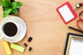 Coffee, book, paperclip, pencil, employee card, post it and tree pot on rustic brown wooden desk. Lifestyle workspace, top view Royalty Free Stock Photo