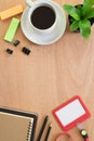 Coffee, book, paperclip, pencil, employee card, post it and tree pot on rustic brown wooden desk. Lifestyle workspace, top view Royalty Free Stock Photo