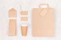 Coffee branding identity mockup - set of brown paper cup with blank bag, label, card, envelope, packet on white wood board. Royalty Free Stock Photo