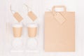 Coffee branding identity mockup - set of two brown paper cups with blank bag, label, cap, sugar on white wood board, top view. Royalty Free Stock Photo