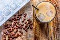 coffee break with cold iced latte and beans on wooden table background top view Royalty Free Stock Photo