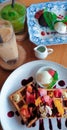 Coffee break with ice cappuccino and Waffle with tropical fruits and ice cream