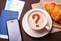 Coffee break, morning coffee. Cup of coffee with foam and croissant with passport