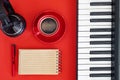 Coffee break at music desk. Flat lay with notebook and digital piano Royalty Free Stock Photo