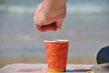 Man is adding some sugar in plastic disposable coffee cup Royalty Free Stock Photo